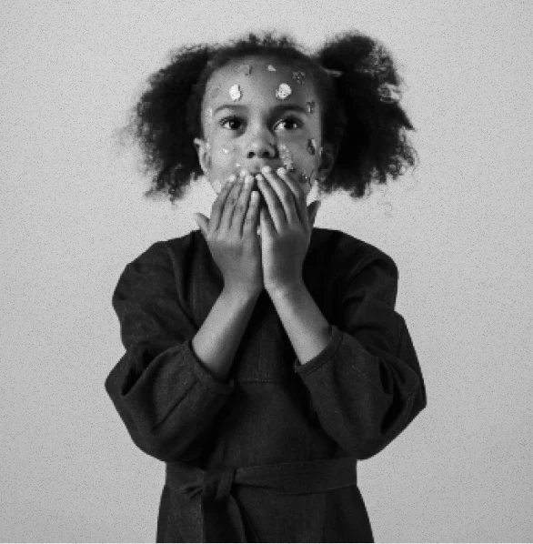 A child in a softly textured dark dress